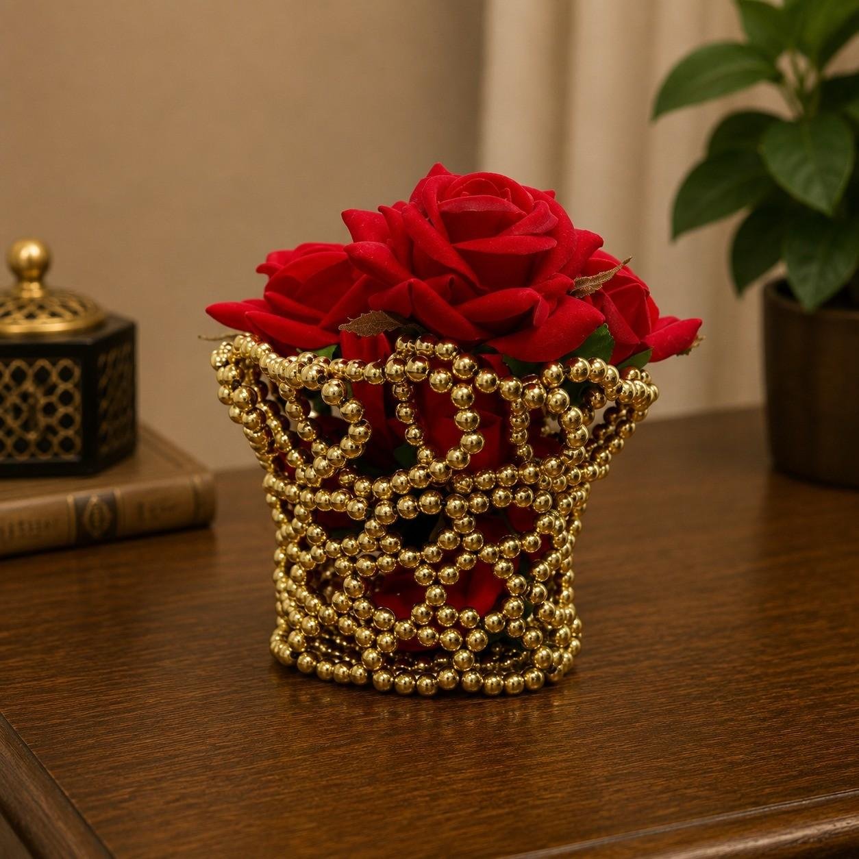 Decorative gold beaded vase with red roses